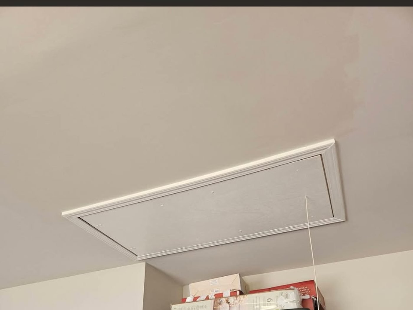 Drywall repair: the repaired ceiling with a clean framed access panel finished flush.