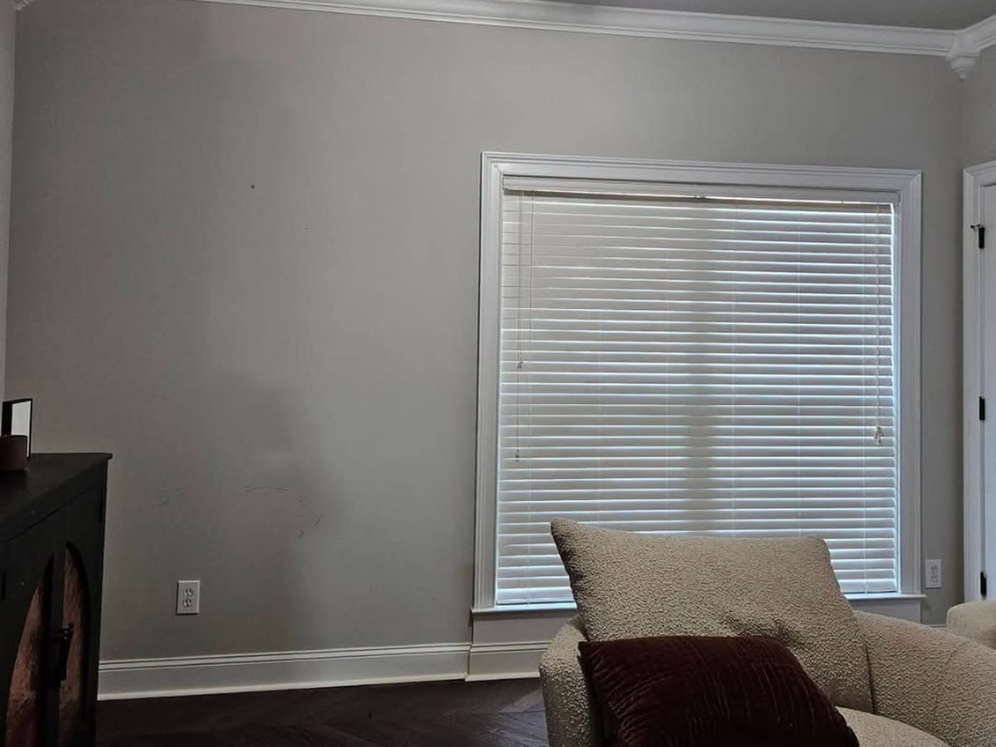 Before the painting: the same living room with flat grey builder-grade walls.