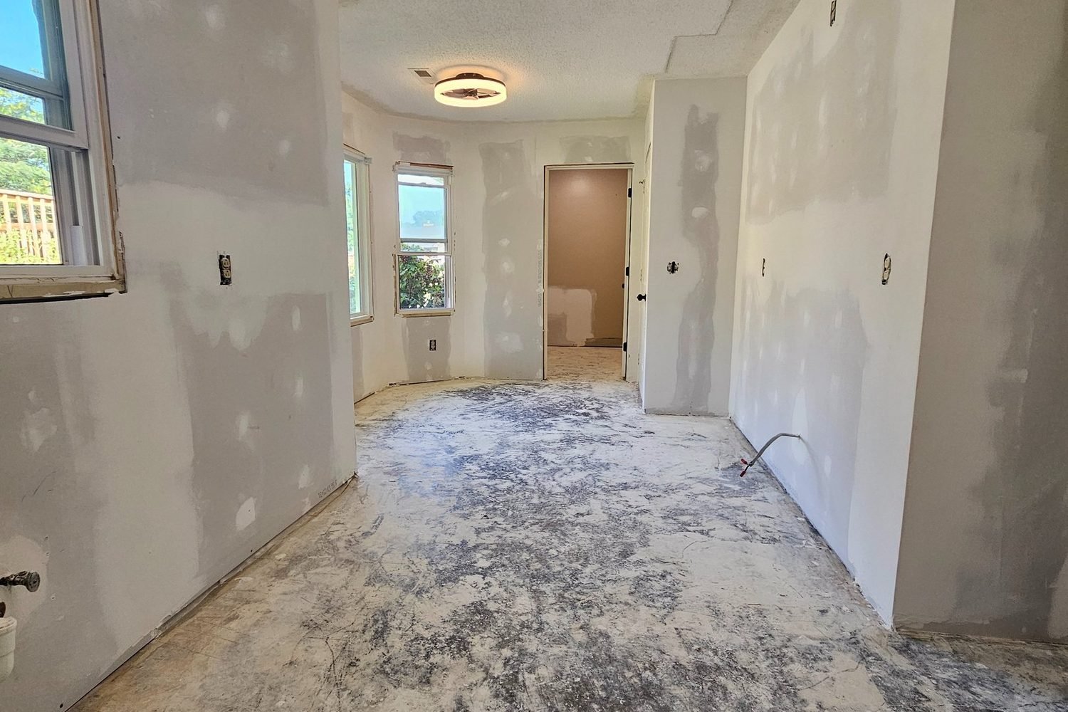 Handyman room renovation in Huntsville, AL: the same sunroom with drywall hung, finished and a new ceiling light.